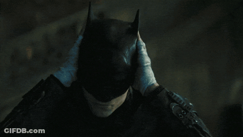 A Person Wearing Gloves Covering Their Face With Their Hands GIF