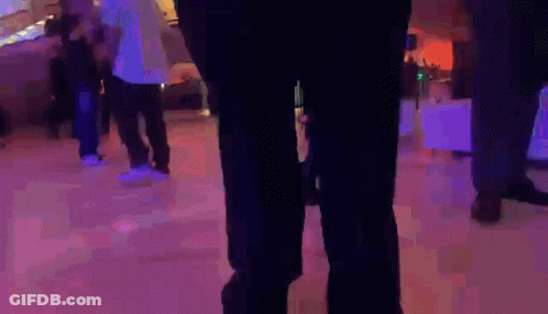 A Person Wearing Green Pants Is Standing On A Ice Rink GIF