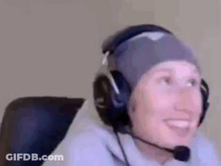 A Person Wearing Headphones And A Beanie Is Smiling . GIF