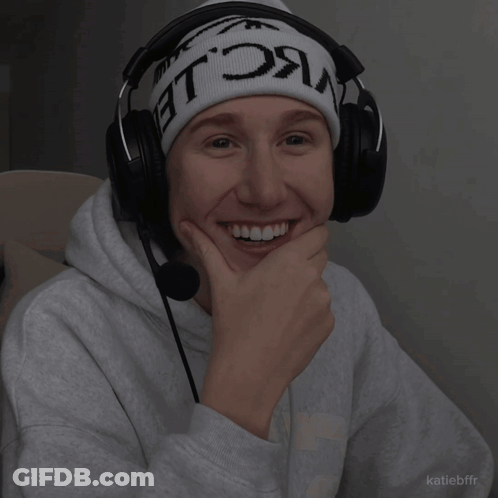 A Person Wearing Headphones And A Beanie That Says ' Nc Le ' On It GIF