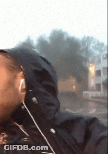 A Person Wearing Headphones And A Black Jacket With A Hood On GIF
