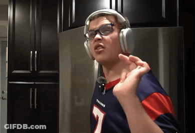 A Person Wearing Headphones And A Texans Jersey GIF