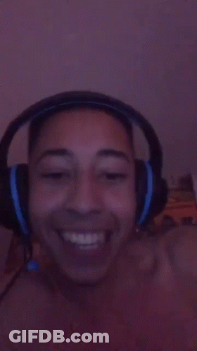 A Person Wearing Headphones Is Smiling And Making A Funny Face GIF