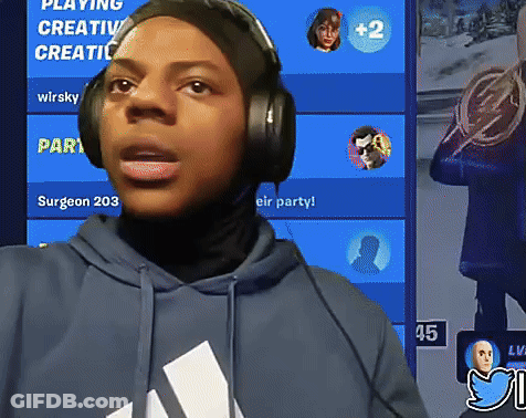 A Person Wearing Headphones Is Standing In Front Of A Blue Screen That Says Playing Creative Creative GIF