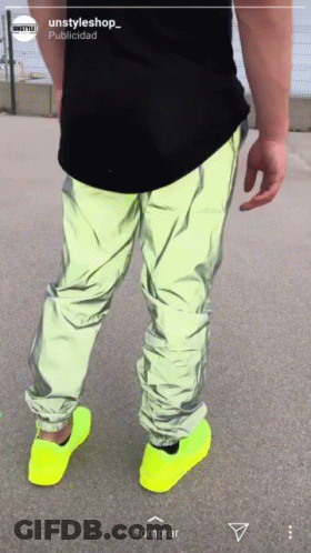 A Person Wearing Neon Yellow Shoes And A Black Shirt With The Words Unstyleshop On The Bottom GIF
