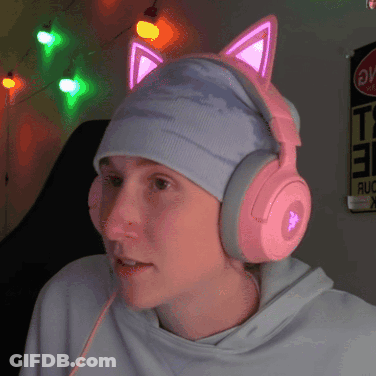 A Person Wearing Pink Headphones And A Hat With Cat Ears On It GIF