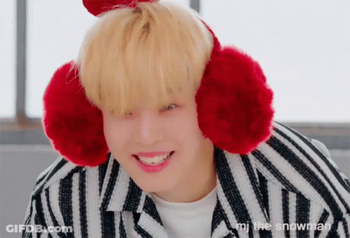A Person Wearing Red Ear Warmers With The Words " I 'M The Snowman " Written Below Them GIF