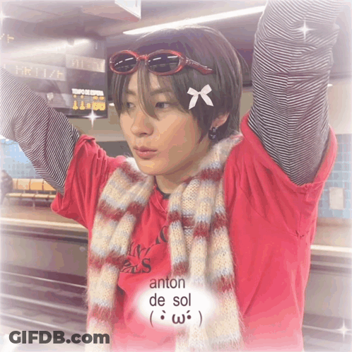 Person With Sunglasses And Scarf With Antón De Sol Text GIF