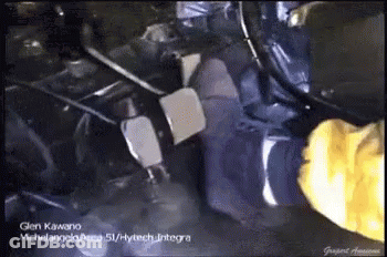 A Person Wearing Yellow Gloves Is Working On A Vehicle GIF
