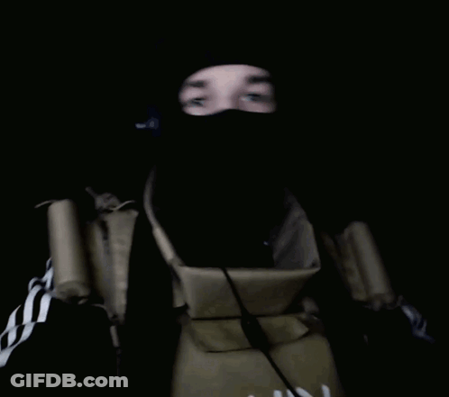 A Person With A Bandaged Hand Is Wearing A Mask And Giving The Middle Finger GIF