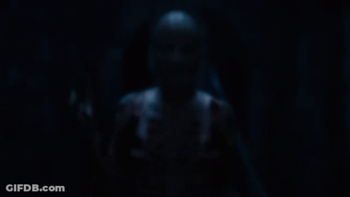 A Person With A Cage Around Their Head Has The Letter S On Their Chest GIF