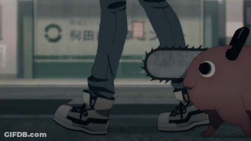 A Person With A Chainsaw Standing Next To A Cartoon Character GIF