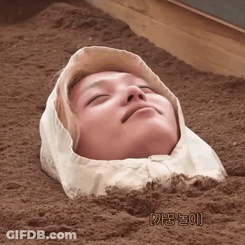 A Person With A Hood On Their Head Is Buried In The Dirt GIF