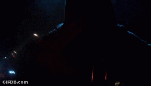 A Person With A Red Lightsaber In Their Hand GIF