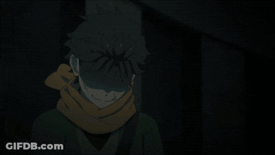 A Person With A Scarf Around Their Neck Stands In The Dark GIF