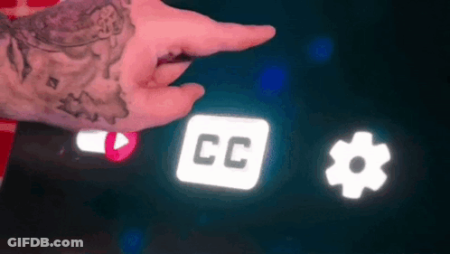 A Person With A Tattoo On Their Wrist Is Pointing At A Screen With A Cc Icon And A Gear Icon . GIF