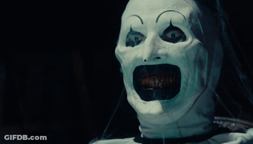 A Person With A White Mask On Their Face Screaming GIF