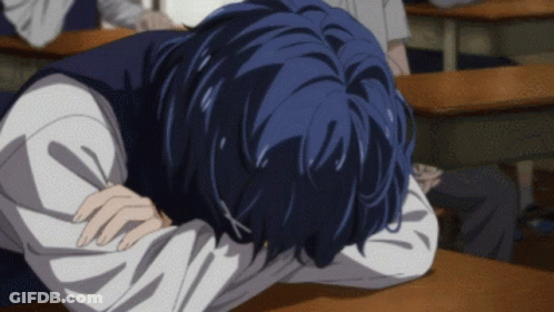 A Person With Blue Hair Is Laying Down On A Desk GIF
