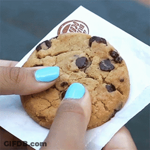 A Person With Blue Nail Polish Is Holding A Burger King Chocolate Chip Cookie GIF