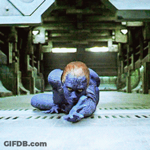 A Person With Blue Paint On Their Body Is Crawling On The Ground GIF