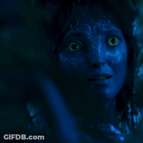 A Person With Blue Paint On Their Face Is Covering Their Mouth With Their Hand GIF