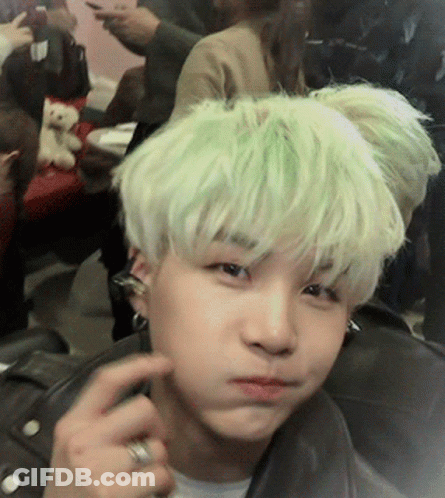 A Person With Green Hair Is Making A Face GIF
