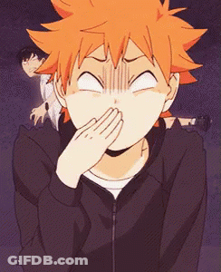 A Person With Orange Hair Is Covering Their Mouth With Their Hand . GIF