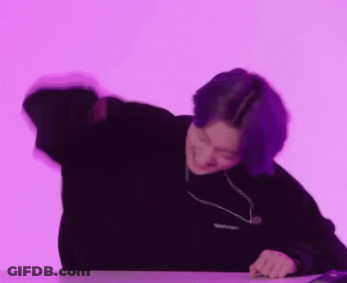 Person With Purple Hair Sitting At Table GIF
