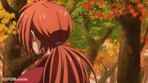 A Person With Red Hair In A Ponytail Looking At Trees GIF