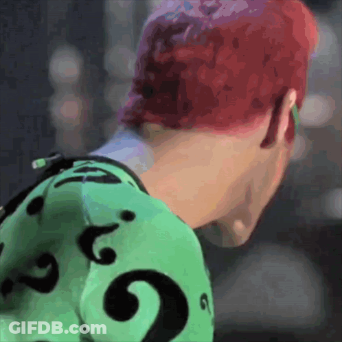 A Person With Red Hair Is Wearing A Green Shirt With A Black Question Mark GIF