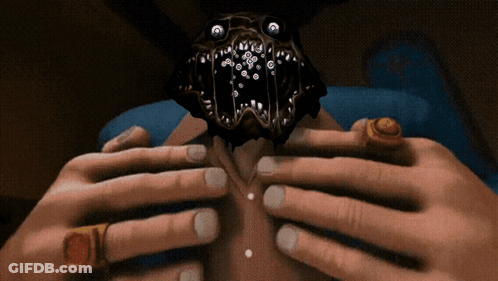 A Person With Rings On Their Fingers Is Holding A Monster GIF