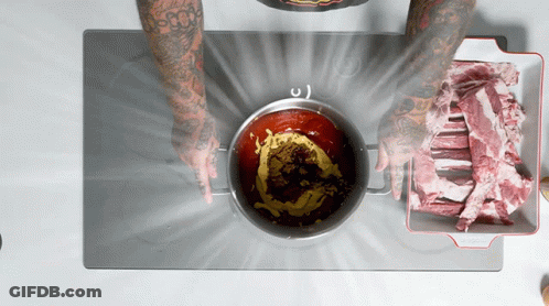 A Person With Tattoos On Their Arms Is Cooking On A Stove Top GIF