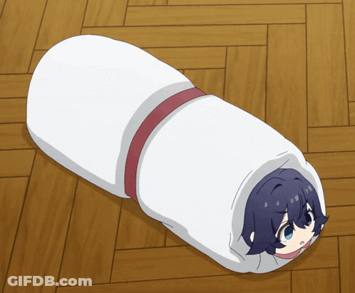 A Person Wrapped In A White Blanket With A Red Ribbon GIF