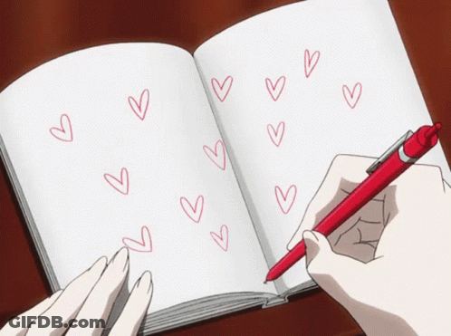 A Person Writing In A Notebook With Hearts Drawn On It GIF