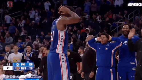 A Philadelphia 76Ers Basketball Player Stands On The Court With His Hands On His Head GIF