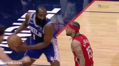 A Philadelphia Basketball Player Dribbles The Ball While Another Player Watches GIF