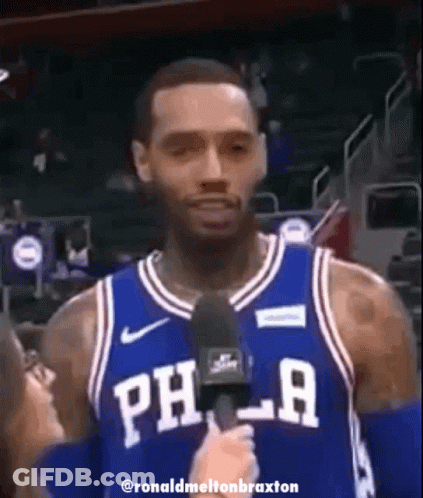 A Philadelphia Basketball Player Is Talking Into A Microphone GIF