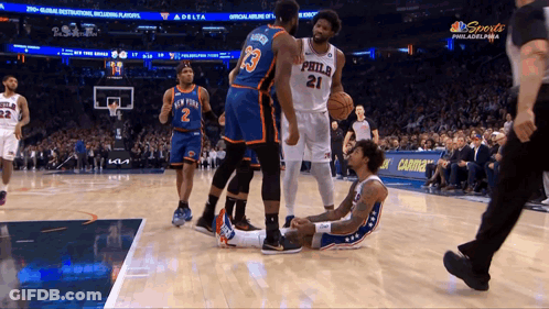 A Philadelphia Basketball Player Lays On The Floor During A Game GIF