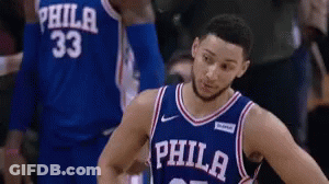 A Philadelphia Basketball Player Stands In Front Of His Teammate GIF