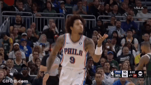 A Philadelphia Basketball Player Stands In Front Of The Crowd GIF