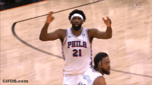 A Philadelphia Basketball Player Wearing Number 21 Is Celebrating On The Court GIF