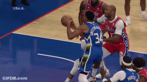 A Philadelphia Basketball Player Wearing Number 34 Tries To Block Another Player GIF