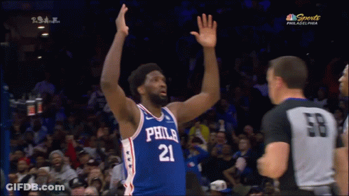 A Philadelphia Basketball Player With His Hands In The Air During A Game GIF