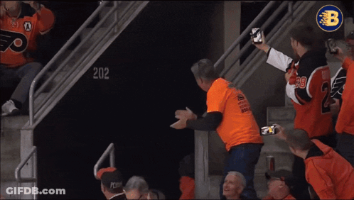 A Philadelphia Flyers Mascot Is Being Attacked By A Fan GIF