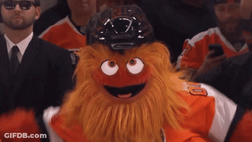 A Philadelphia Flyers Mascot Is Wearing A Helmet And Sunglasses GIF