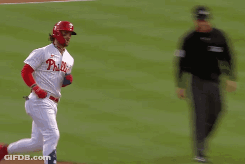 A Philadelphia Phillies Baseball Player Is Running Towards A Referee GIF