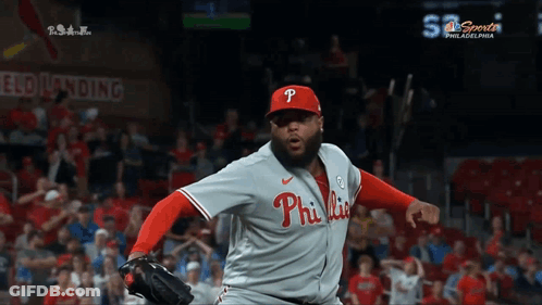 A Philadelphia Phillies Pitcher Throws A Ball In Front Of A Crowd GIF