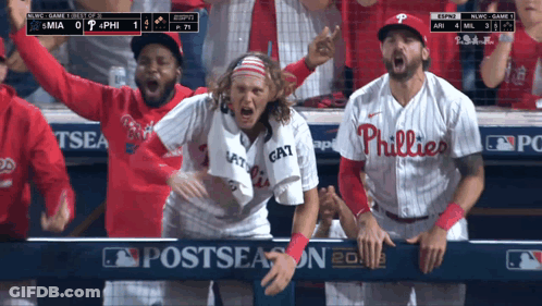 A Philadelphia Phillies Player Stands In The Dugout With His Teammates GIF