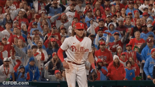 A Phillies Baseball Player Stands In Front Of A Crowd Of People GIF