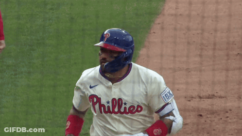 A Phillies Baseball Player Wearing A Helmet And White Jersey GIF
